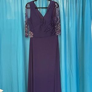 Floorlength purple gown with beautiful gemstone beading and invisible sleeves.
